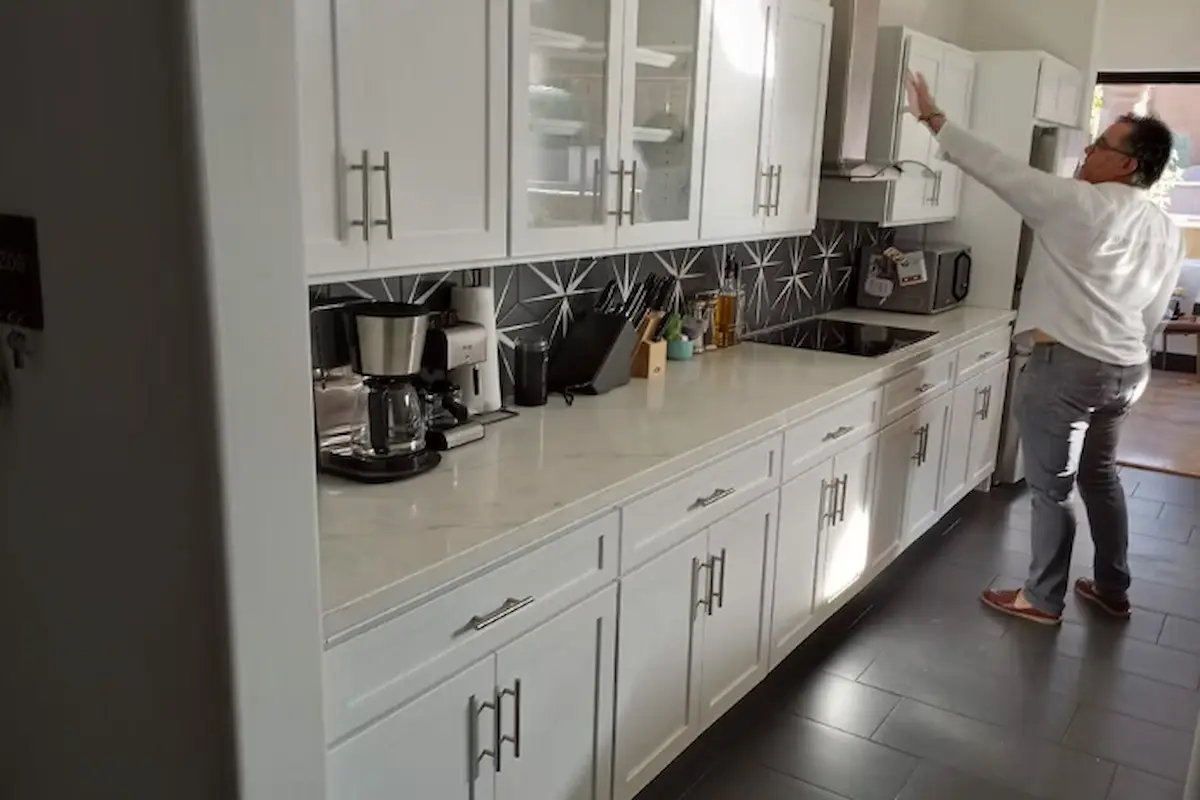Refinished white kitchen cabinets in a bright Phoenix home with modern hardware and a clean factory-smooth finish.